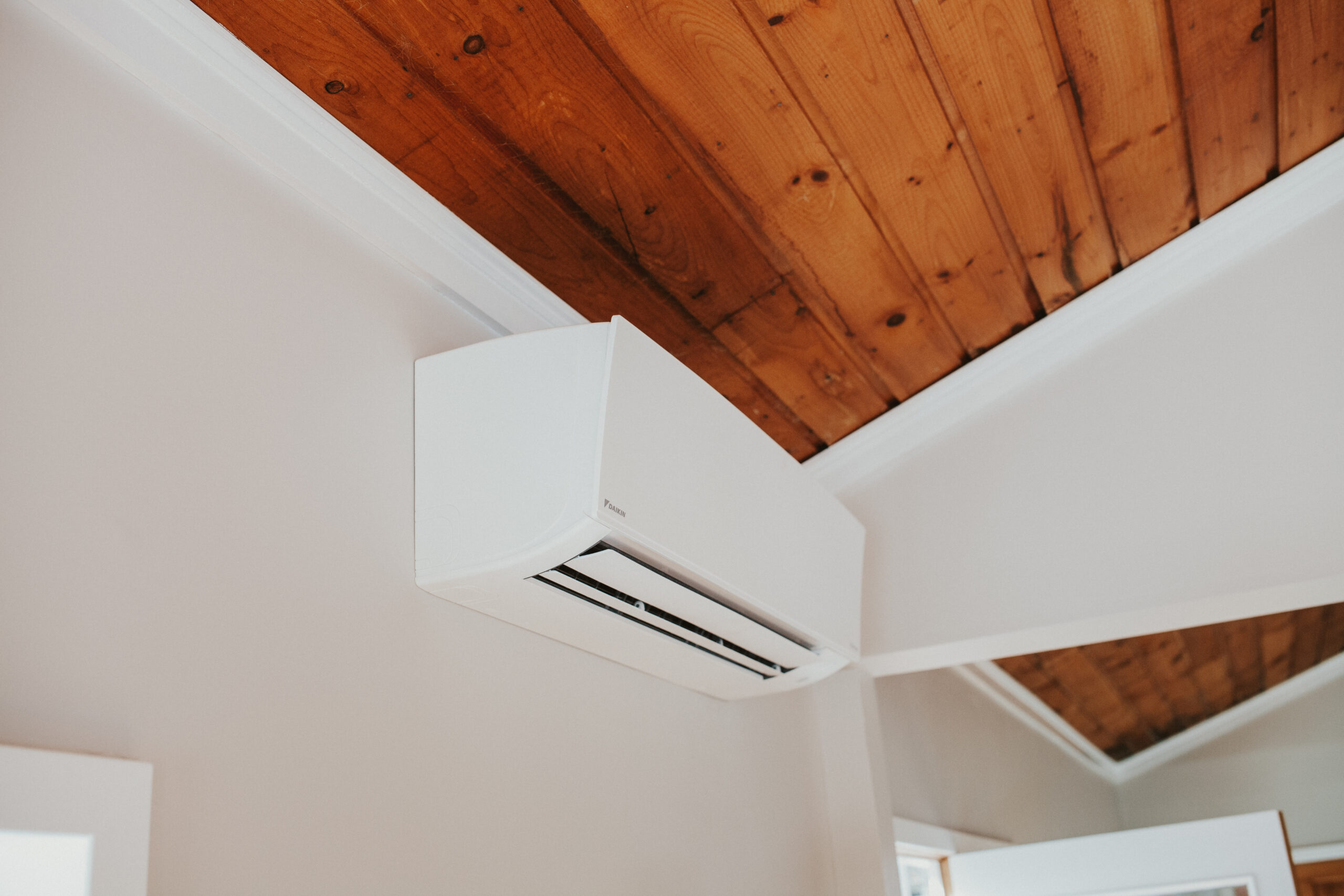 IMG_2036 Wall-mounted ductless mini split air conditioning unit installed in a modern residential living room.