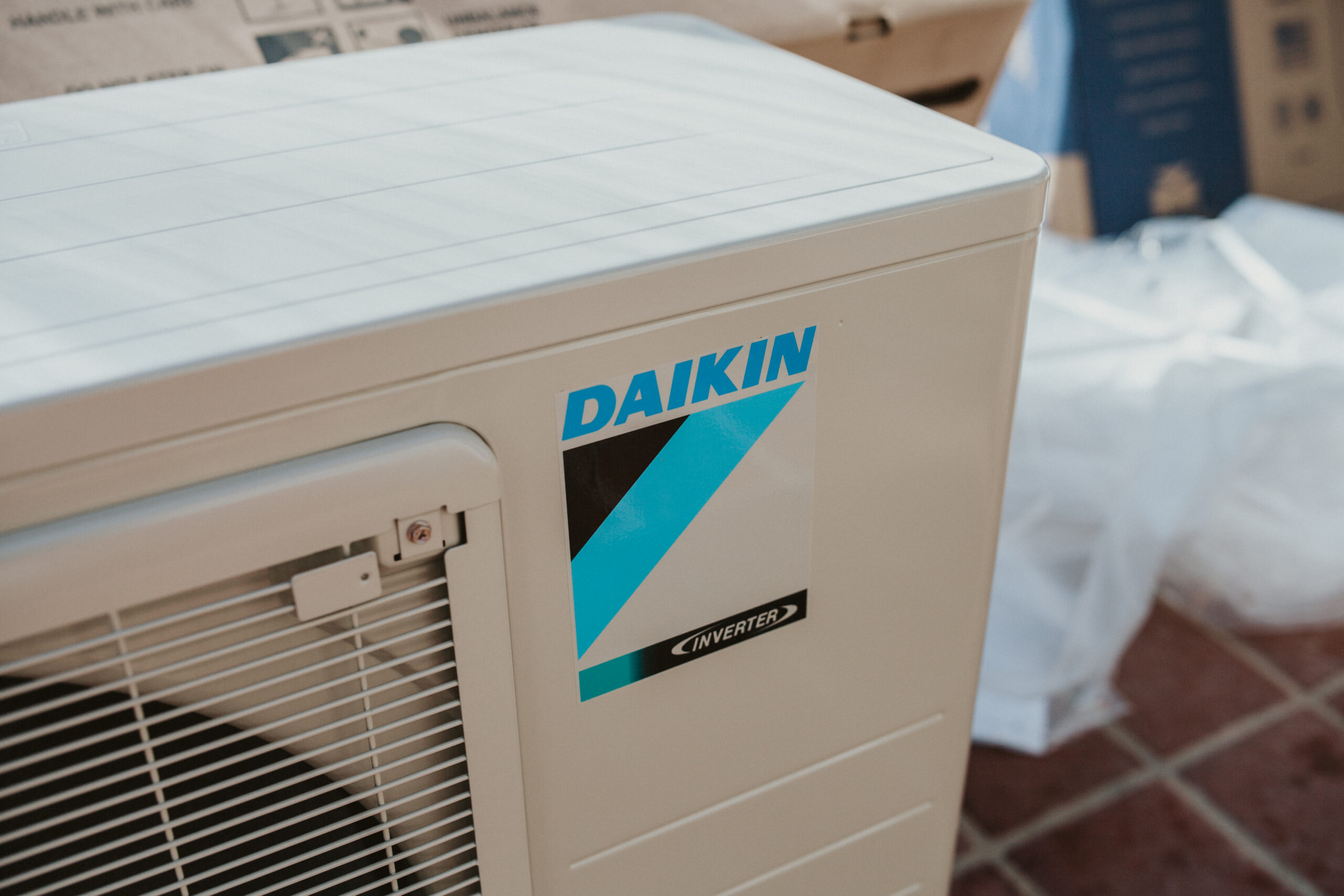IMG_2085 Outdoor Daikin air conditioning unit installed beside a residential home, part of a high-efficiency cooling system.